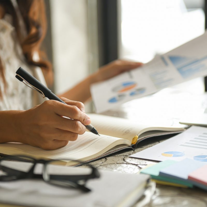 Business women are checking the company performance chart. Business women are checking the company performance chart.